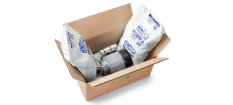 A cardboard box containing a component and plastic bags with packaging chips